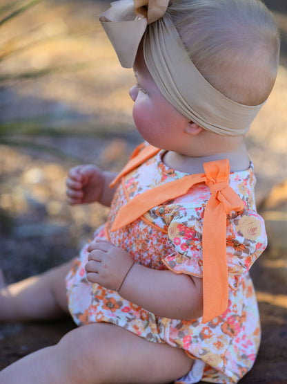 Baby Girls Peach Floral Smocked Bubble Romper | Bow Shoulder Puff Sleeve